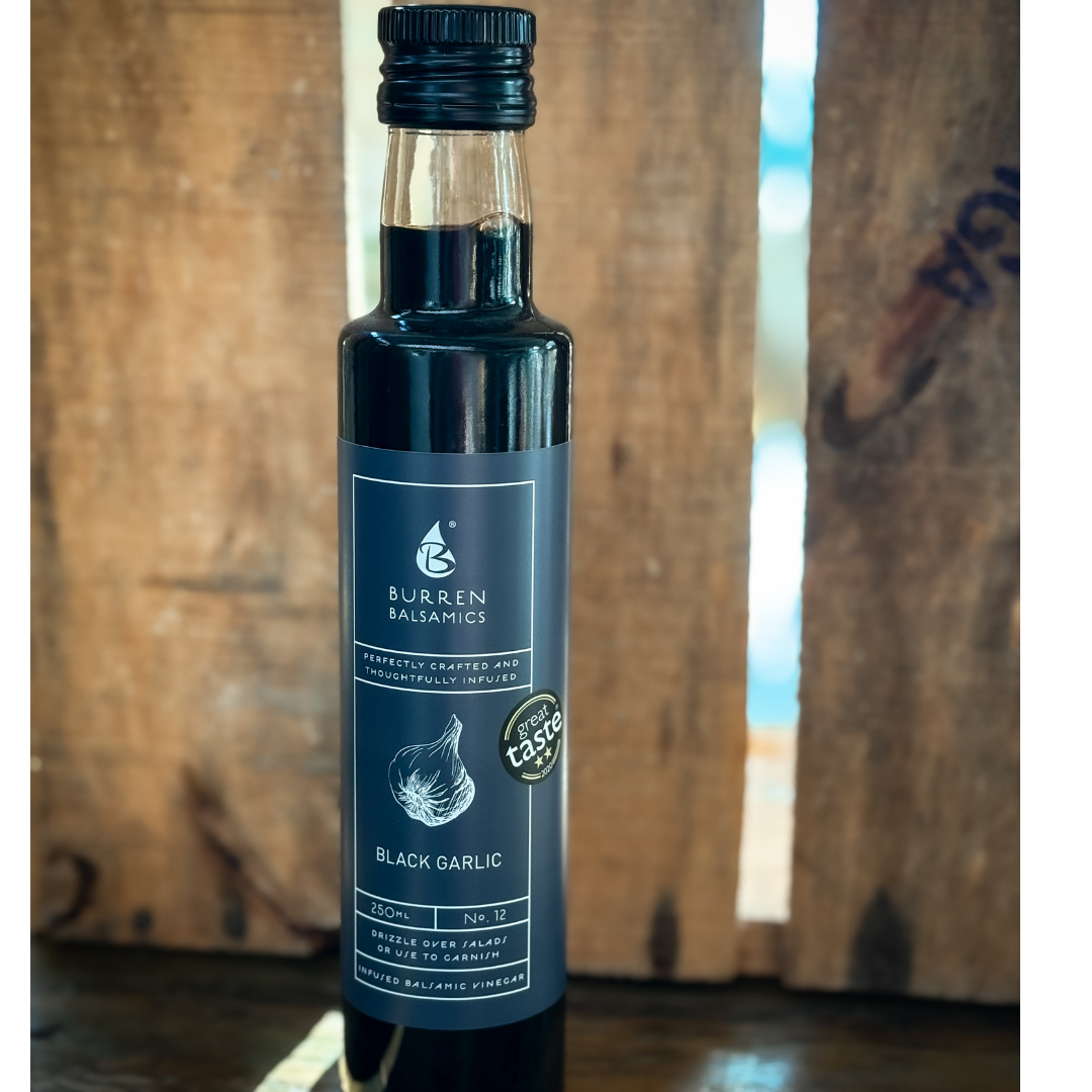 Bottle of balsamic vinegar against a wooden background