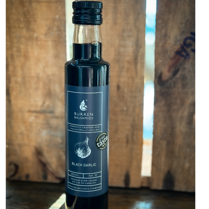 Bottle of balsamic vinegar against a wooden background