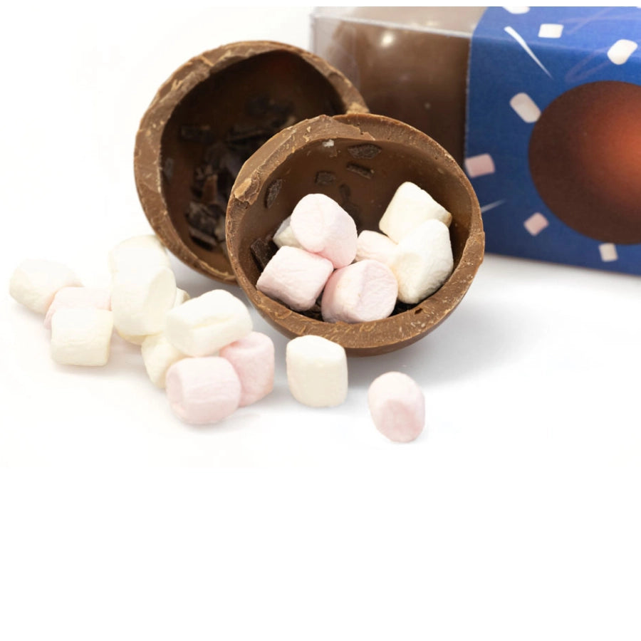 A gift box containing one serving of Chocolate Garden Hot Chocolate Bombe, with a floral design on the box and a golden bow on top.