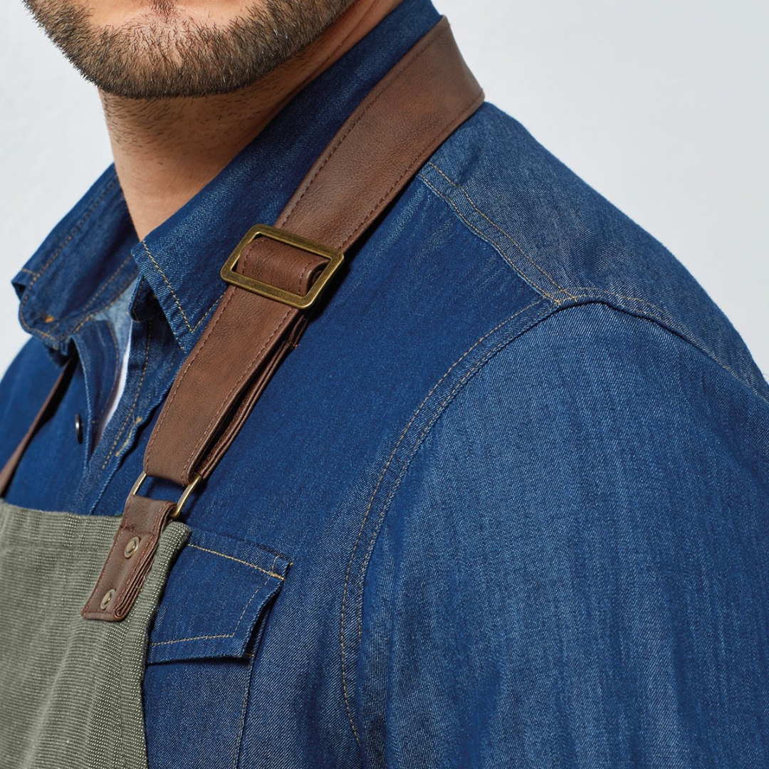Close up of neck of forest apron with a white and denim background