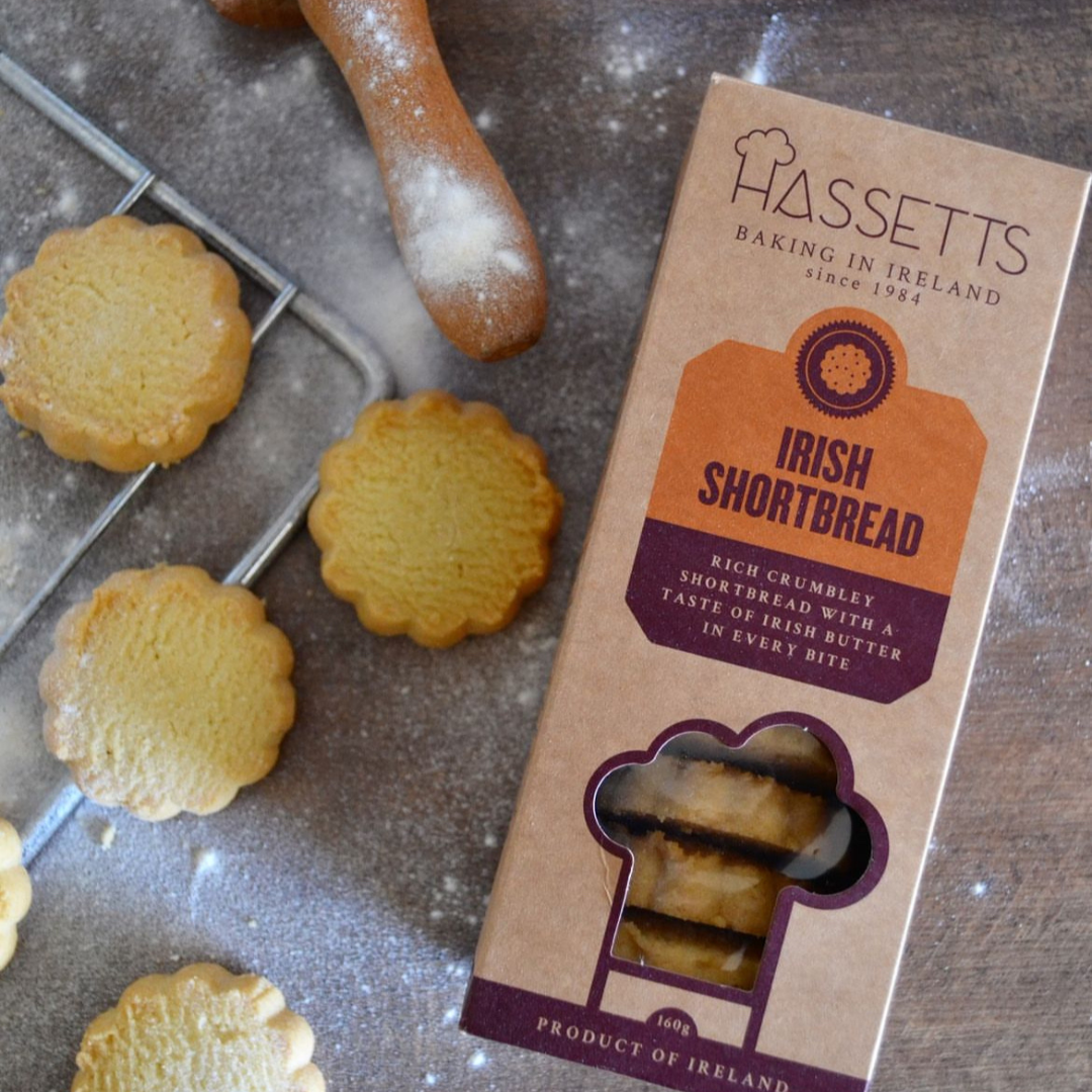 Cardboard box of biscuits with baked cookies in the background