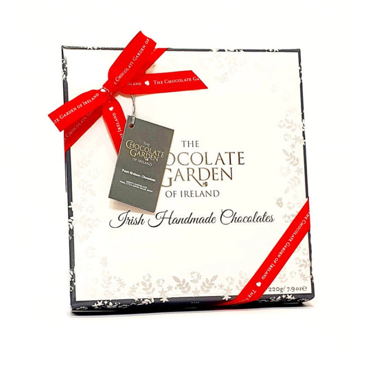 A box of Chocolate Garden of Ireland handmade luxury chocolates, with a red ribbon and a tag displaying the brand and product name.