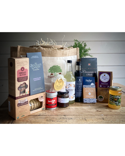 Assorted products including bottles, jars, and boxes on a wooden surface with a white background.