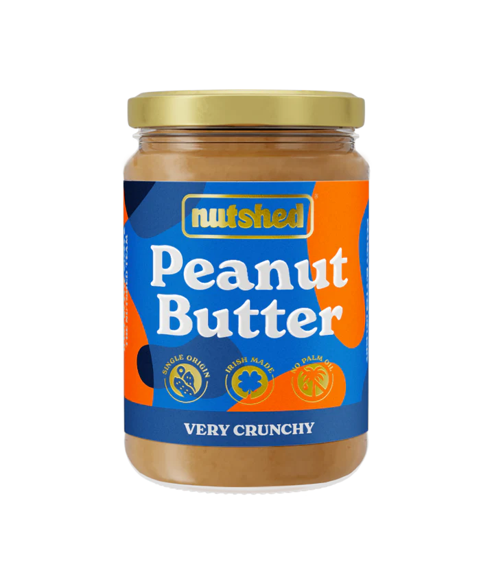 Jar of peanut butter against a black and grey checkered background