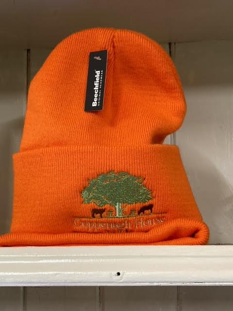 An orange beanie hat with an embroidered logo on the front.