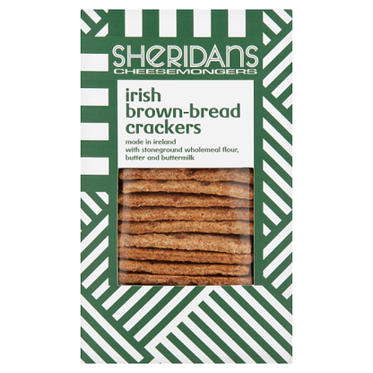 Packaging for Sheridans Brown Bread Crackers showing the crackers visible through the clear window, with green and white geometric patterns and product details.