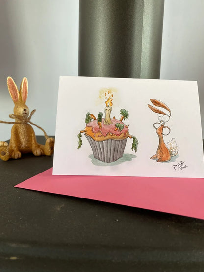 Card with a rabbit looking at a birthday carrot cake