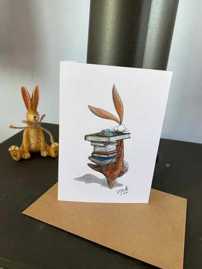 Card with a rabbit carrying a pile of books