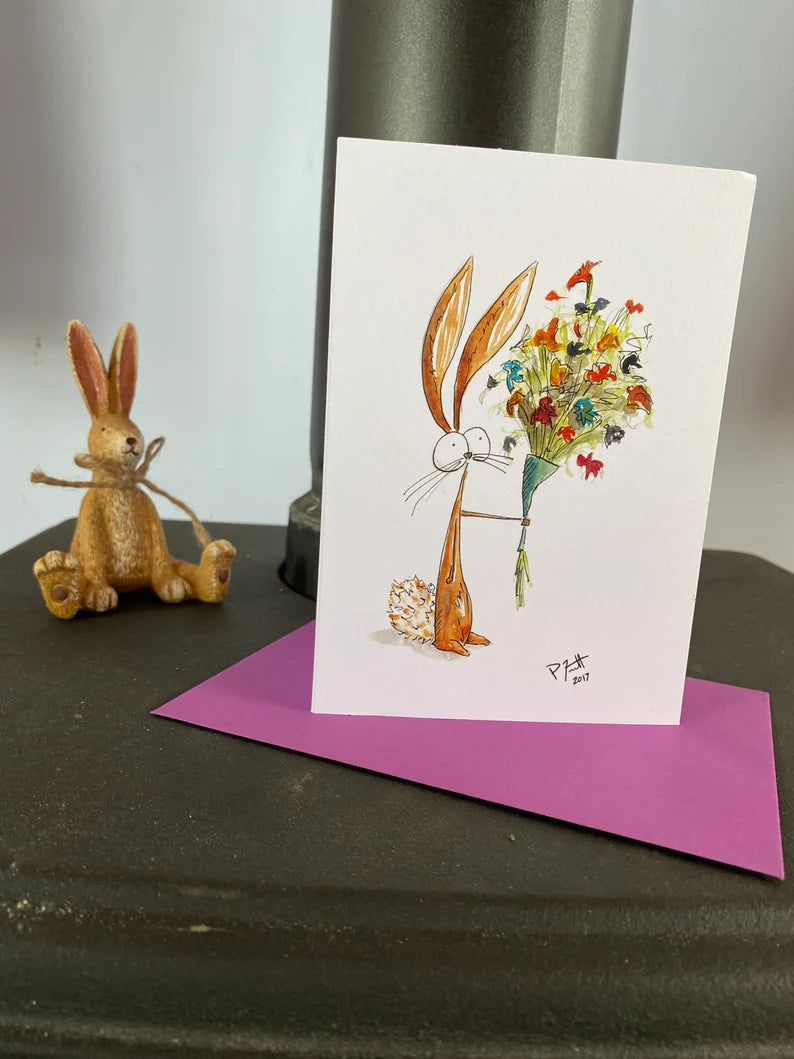 Card with a rabbit holding a flower bouquet