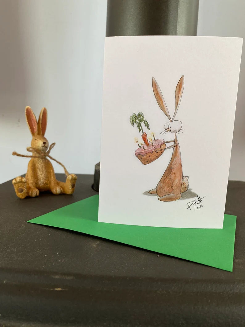 Card with a rabbit holding a birthday carrot cake