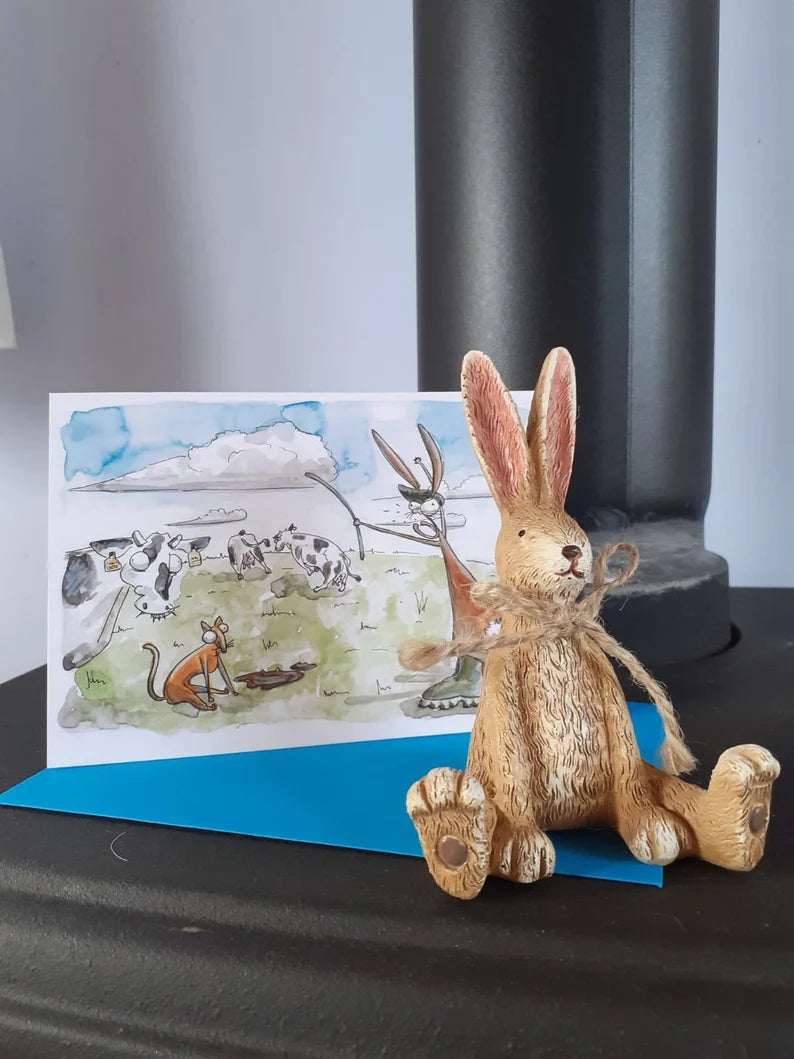 Card with a farmer rabbit with his cat and cattle