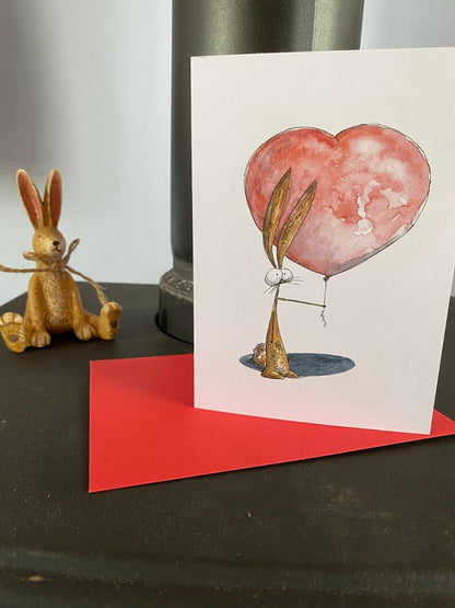 Card with a rabbit holding a heart balloon