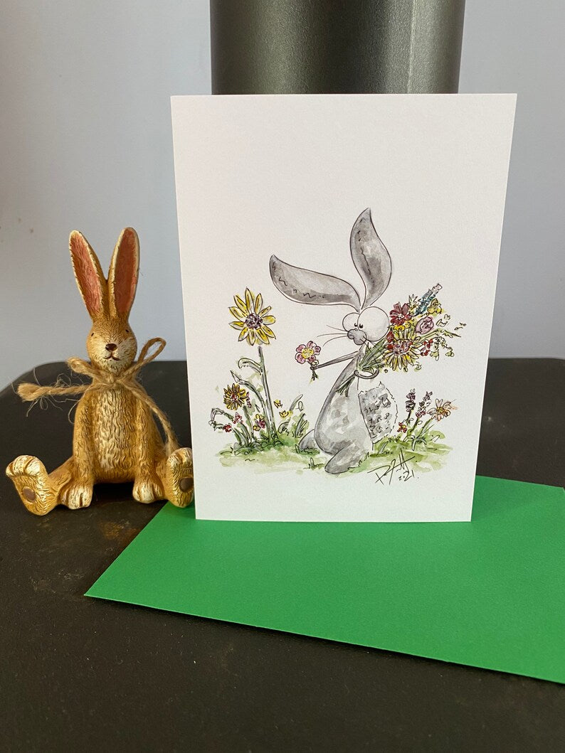 Card with a rabbit picking flowers