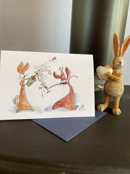 Card with two rabbits popping open champagne