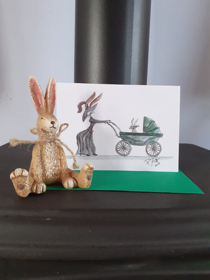 Card with a rabbit pushing a baby rabbit in a pram